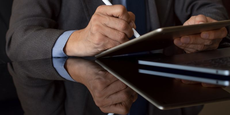 A lawyer signing a document electronically.