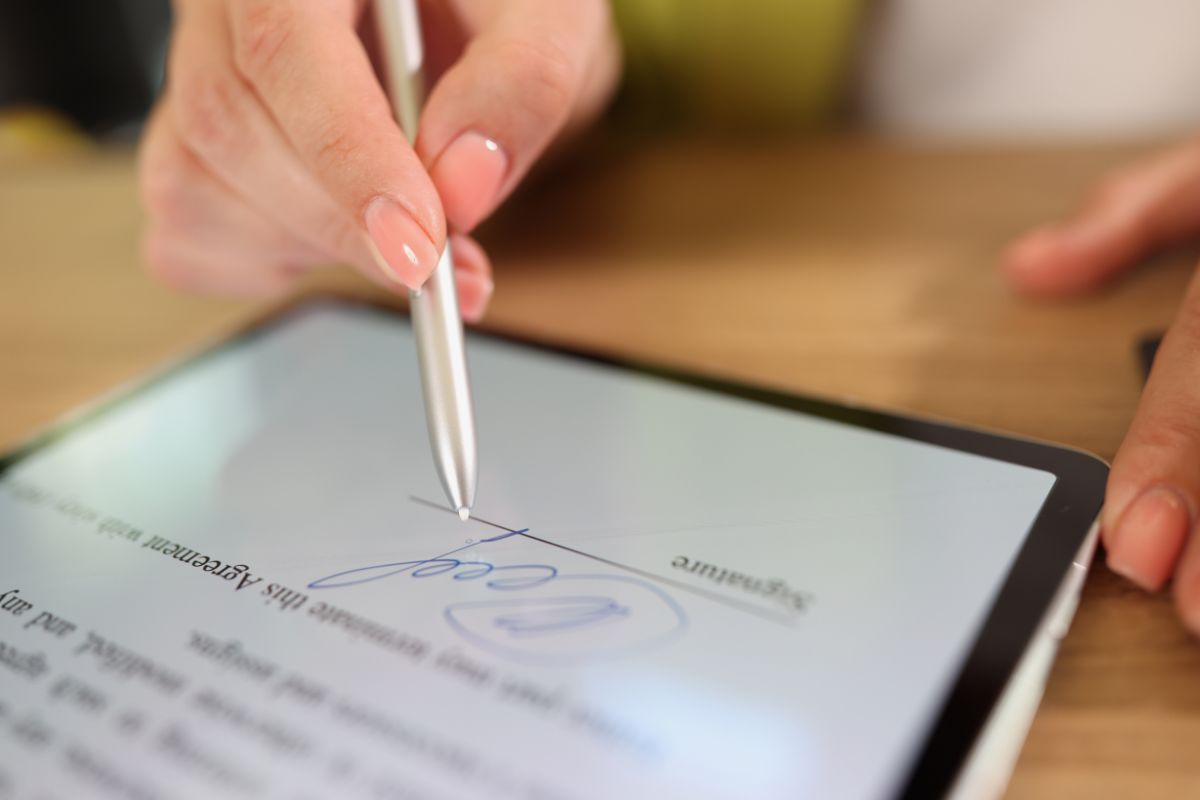 The person inserts the signature in a Word document.