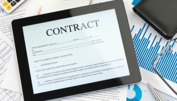 The iPad shows an online contract.